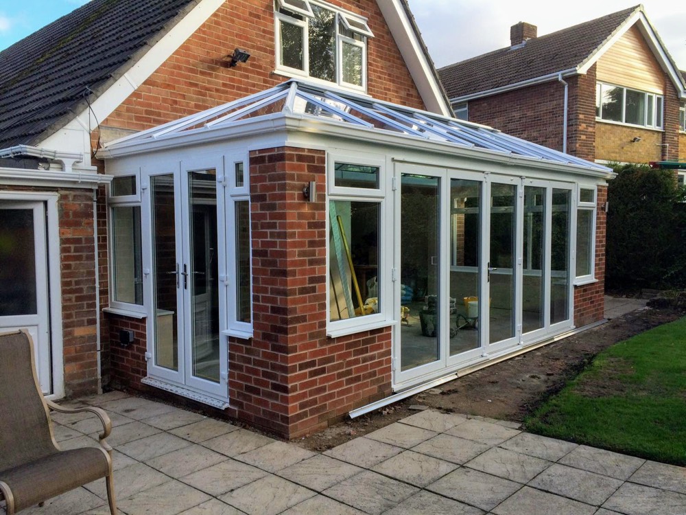 Finished bespoke conservatory with glass roof lantern and white-frame bifold doors, installed by AGG in Gateacre, Liverpool
