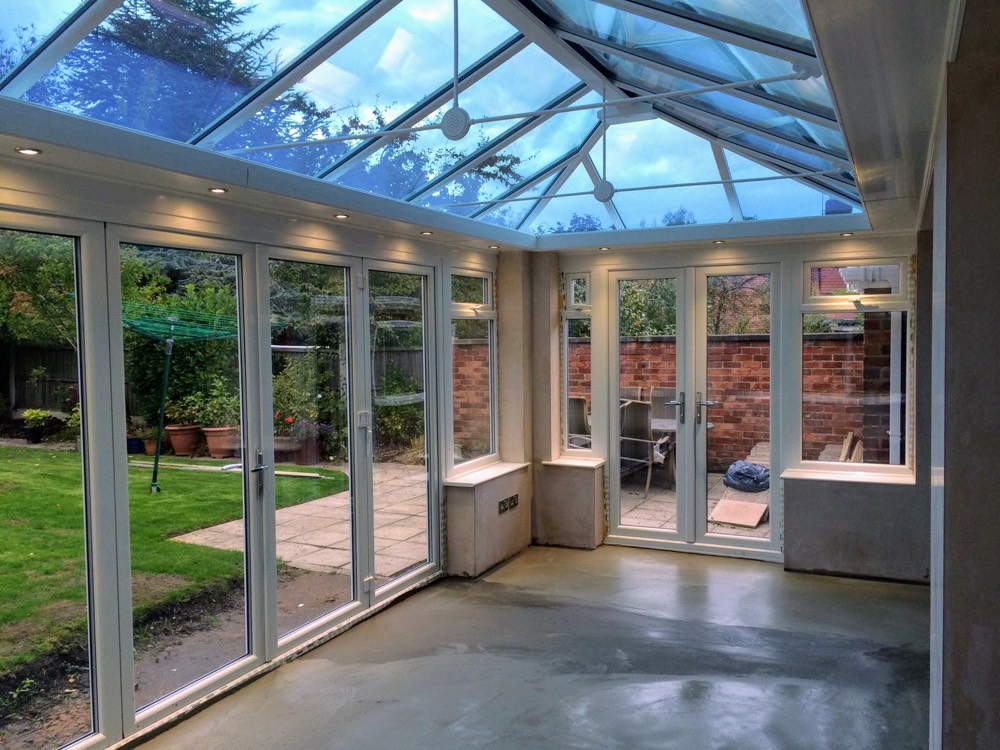 Glass-roof box extension interior with full-height glazing and bifold doors