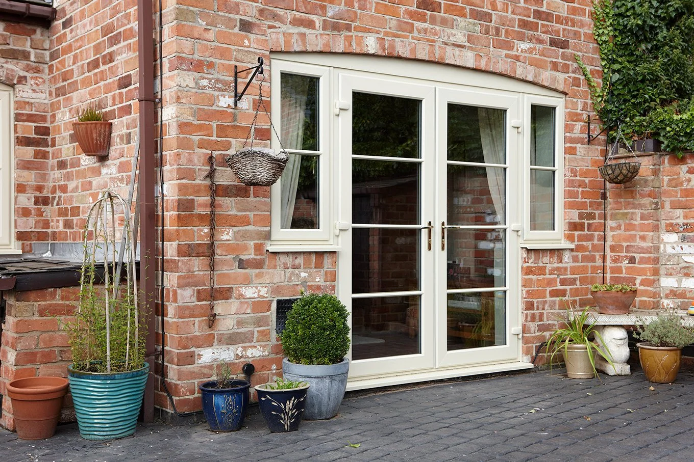 Cream UPVC French doors on a traditional brick property