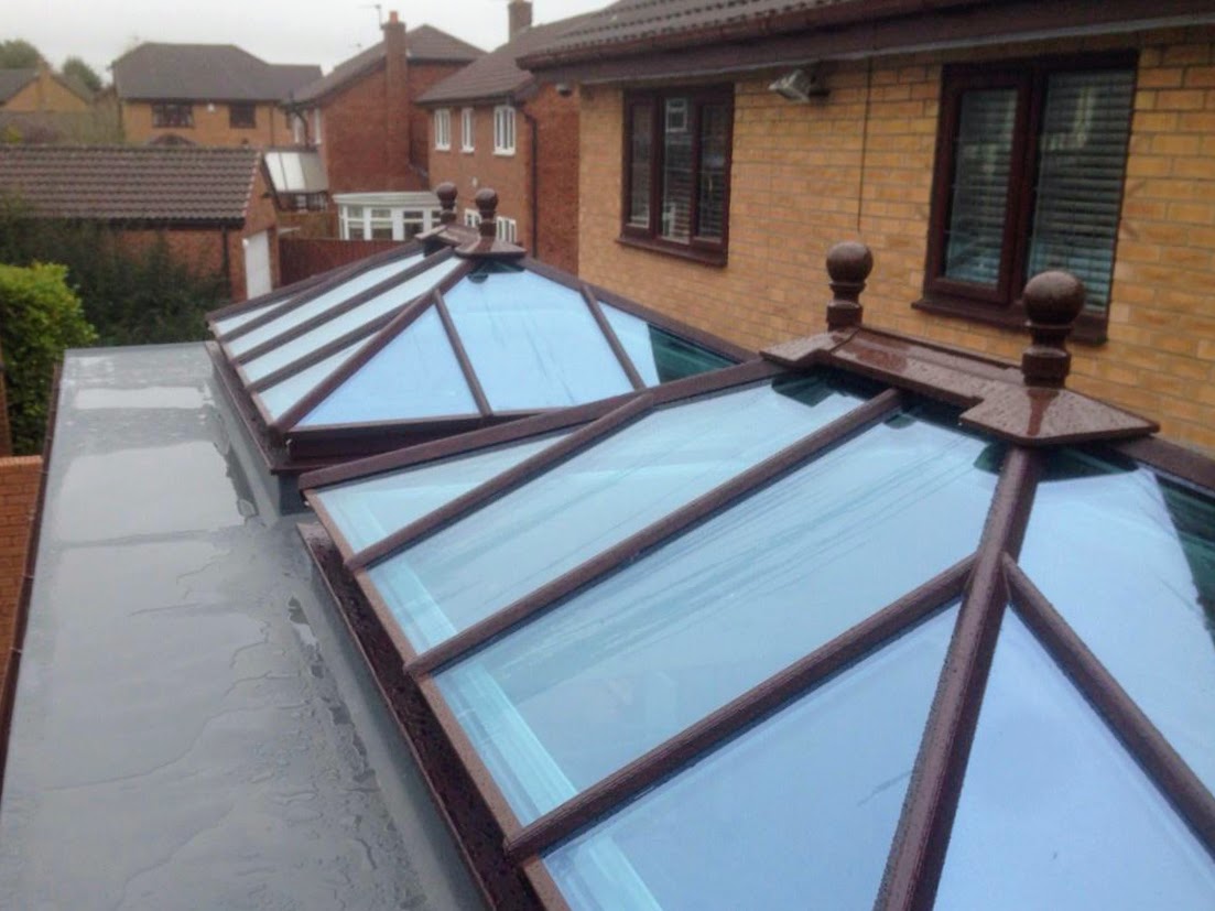 Pair of mahogany-frame glass roof lanterns on a flat-roof rear extension