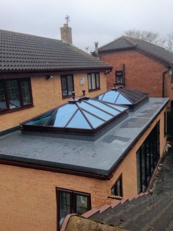 Pair of pitched glass roof lanterns on a flat-roof extension