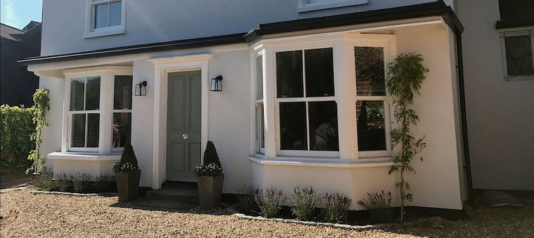 Traditional sliding sash windows on a heritage brick cottage